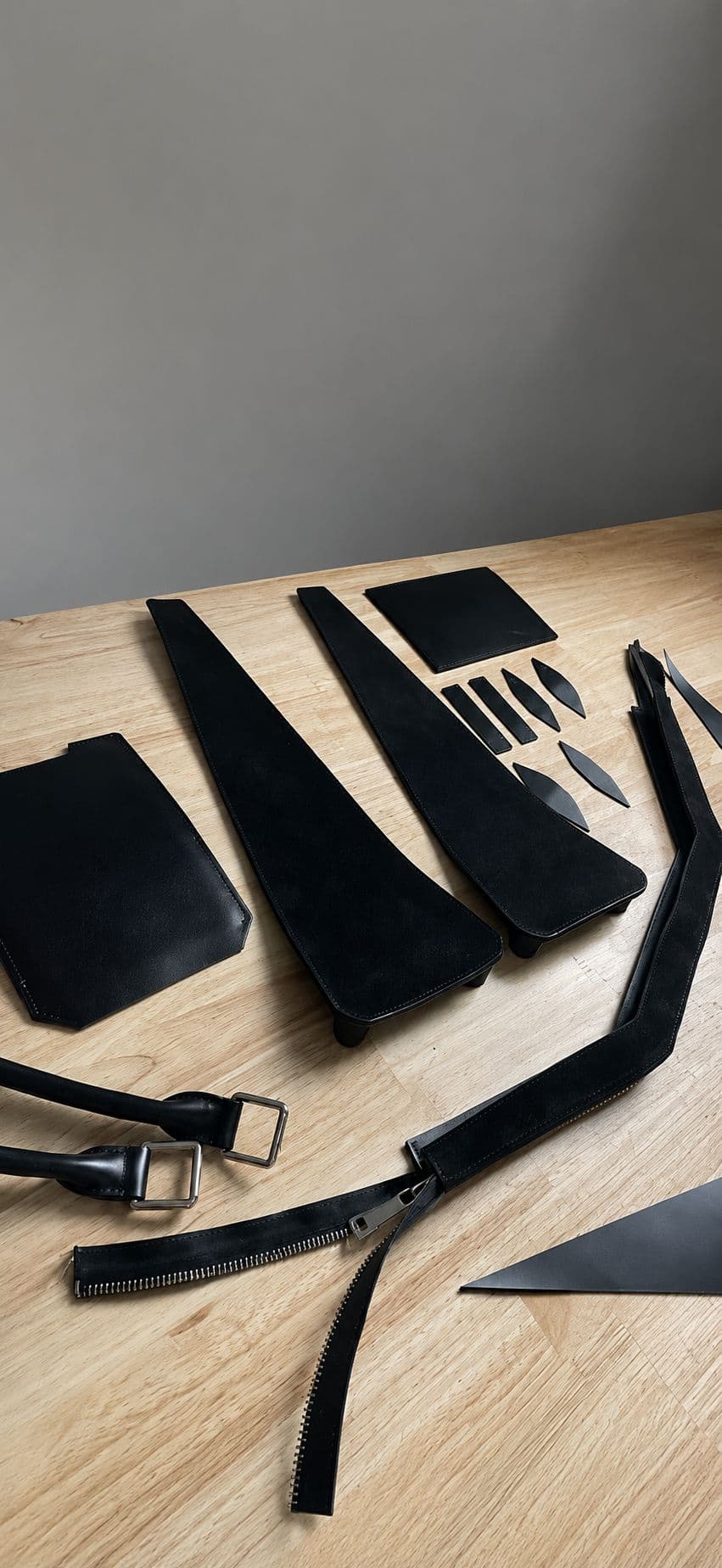 Hand-cut leather components prepared for assembly at the Nostradovus atelier